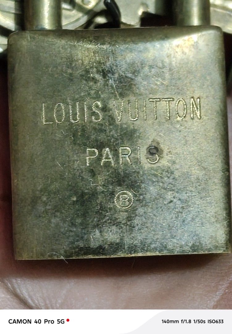Louis Vuitton Padlock with Keys (Category: Luxury Bags & Wallets) located in San Pedro. Submitted by tristanjapansurplus (Listing ID 1397411682, Image 3). Description: - Authentic Louis Vuitton padlock - Includes two keys - Features Louis Vuitton logo and "PARIS" engraving - Key number: 218 - Made of brass.