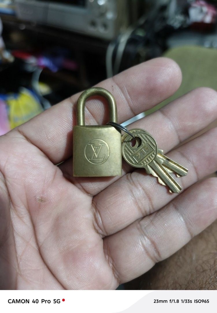 Louis Vuitton Padlock with Keys (Category: Luxury Bags & Wallets) located in San Pedro. Submitted by tristanjapansurplus (Listing ID 1397411682, Image 1). Description: - Authentic Louis Vuitton padlock - Includes two keys - Features Louis Vuitton logo and "PARIS" engraving - Key number: 218 - Made of brass.