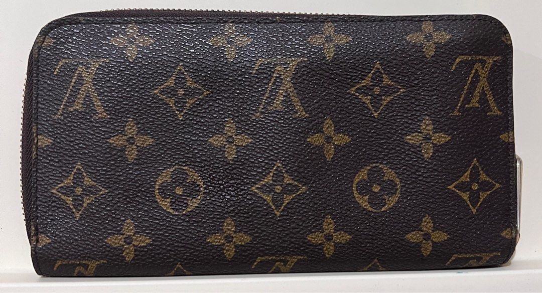 LV Zippy Wallet (Category: Luxury Bags & Wallets) located in San Fernando. Submitted by klutzy_kloset (Listing ID 1397418365, Image 2). Description: For sale: LV Wallet featuring the iconic monogram canvas exterior, gold interior lining, multiple compartments and card slots. It has an engraved Louis Vuitton 5 Canton Road Hong Kong plate on the front. Issues: This was bought at a vintage shop so expect signs of use. No leather peeling but interior