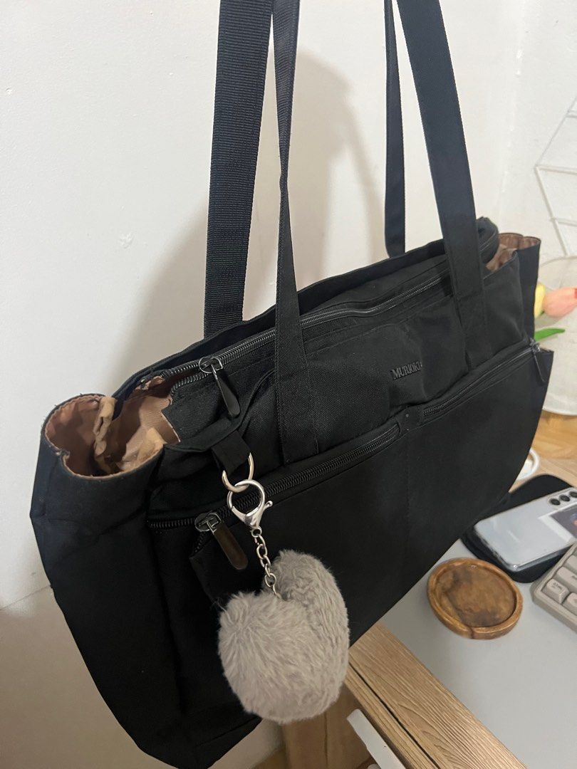 Muroki Black Tote Bag with Charm (Category: Tote Bags) located in Cabanatuan. Submitted by didicstll (Listing ID 1397531398, Image 2). Description: - Muroki black tote bag - Multiple zippered compartments - Long shoulder straps - Includes heart-shaped charm - Patterned interior lining - Durable and possibly water-resistant material - Ideal for everyday use.