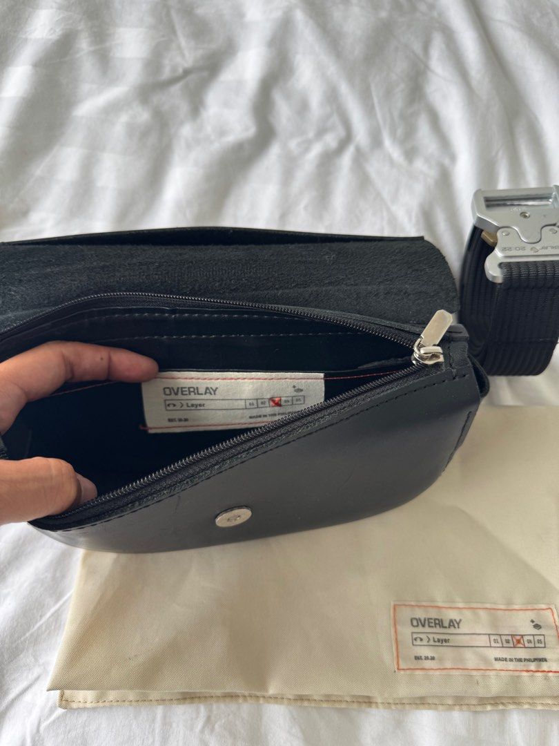 Overlay Bag with Belt (Category: Luxury Bags & Wallets) located in Mandaluyong City. Submitted by ukanification (Listing ID 1397465654, Image 3). Description: - Black leather overlay rafael bag - Includes matching belt which can be worn separately - Flap closure - Small interior pocket - Comes with dust bag - Metal buckle on belt - Perfect for everyday wear.