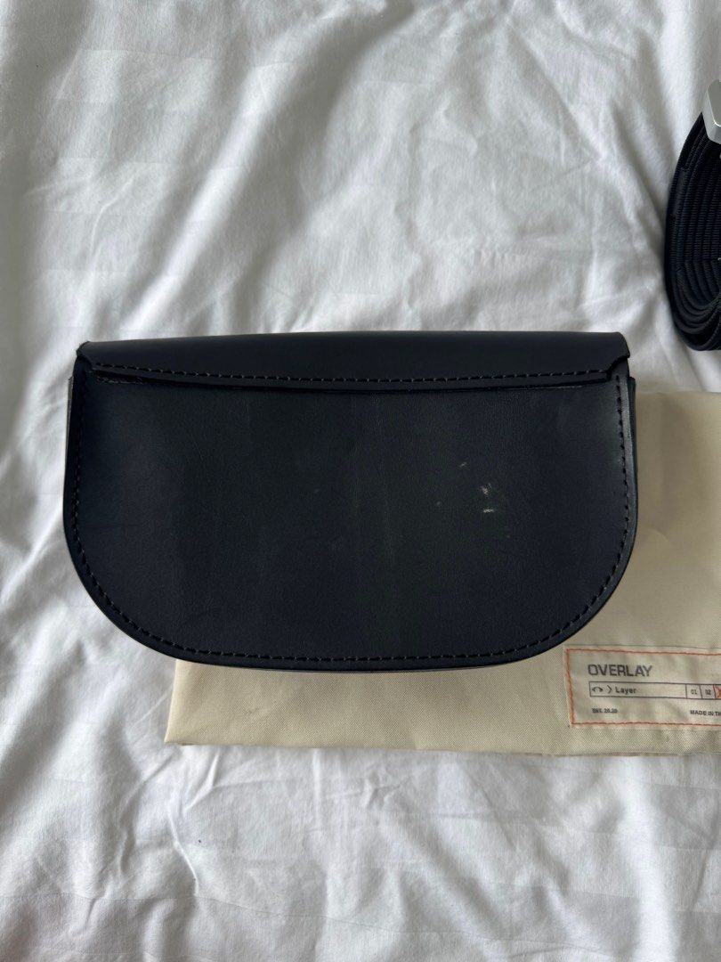 Overlay Bag with Belt (Category: Luxury Bags & Wallets) located in Mandaluyong City. Submitted by ukanification (Listing ID 1397465654, Image 2). Description: - Black leather overlay rafael bag - Includes matching belt which can be worn separately - Flap closure - Small interior pocket - Comes with dust bag - Metal buckle on belt - Perfect for everyday wear.