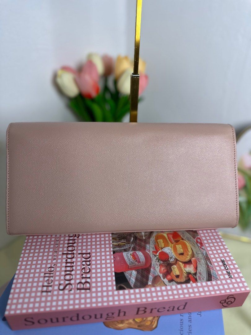 Saint Laurent YSL Sac Cassandre Clutch (Category: Luxury Bags & Wallets) located in Cagayan de Oro. Submitted by thecdobags (Listing ID 1397563191, Image 3). Description: - Authentic Saint Laurent clutch - Soft pink color - Gold YSL logo - Black interior - Includes authenticity cards and receipt - Made in Italy.