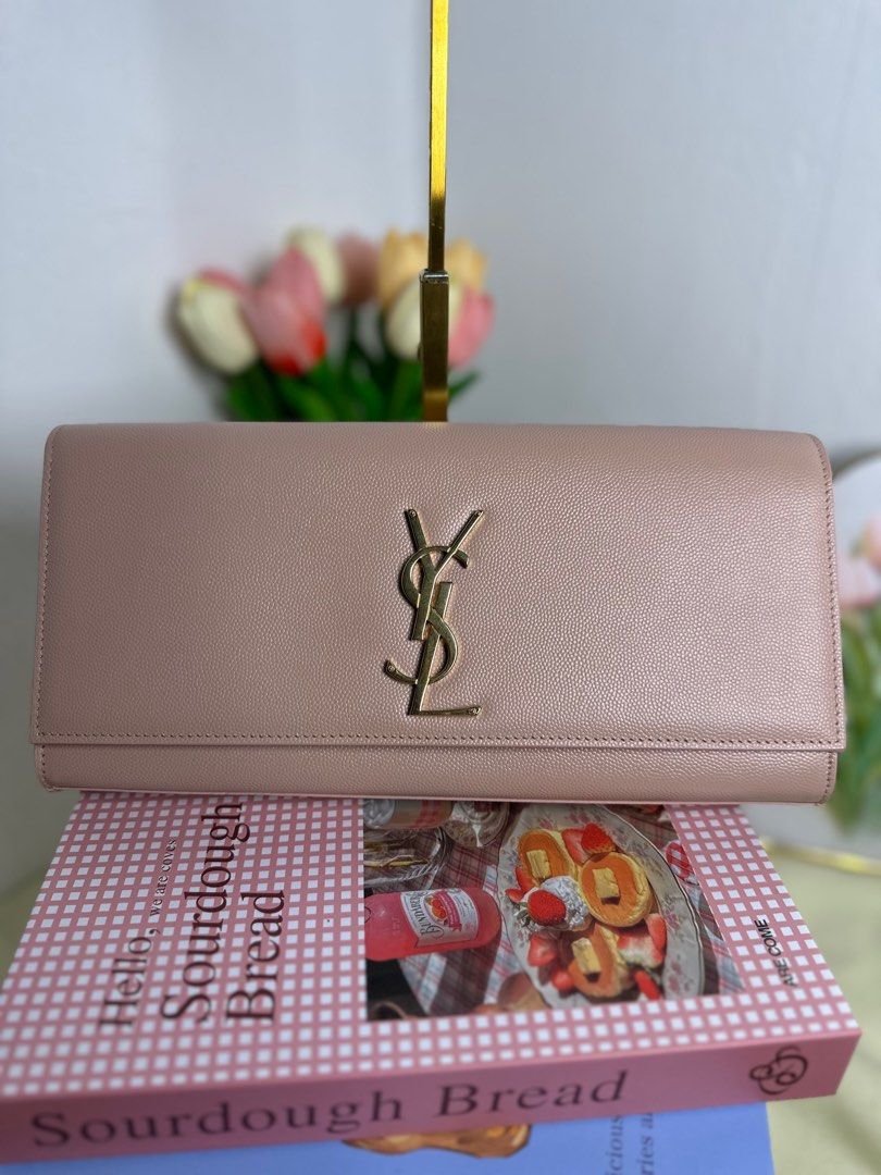 Saint Laurent YSL Sac Cassandre Clutch (Category: Luxury Bags & Wallets) located in Cagayan de Oro. Submitted by thecdobags (Listing ID 1397563191, Image 1). Description: - Authentic Saint Laurent clutch - Soft pink color - Gold YSL logo - Black interior - Includes authenticity cards and receipt - Made in Italy.