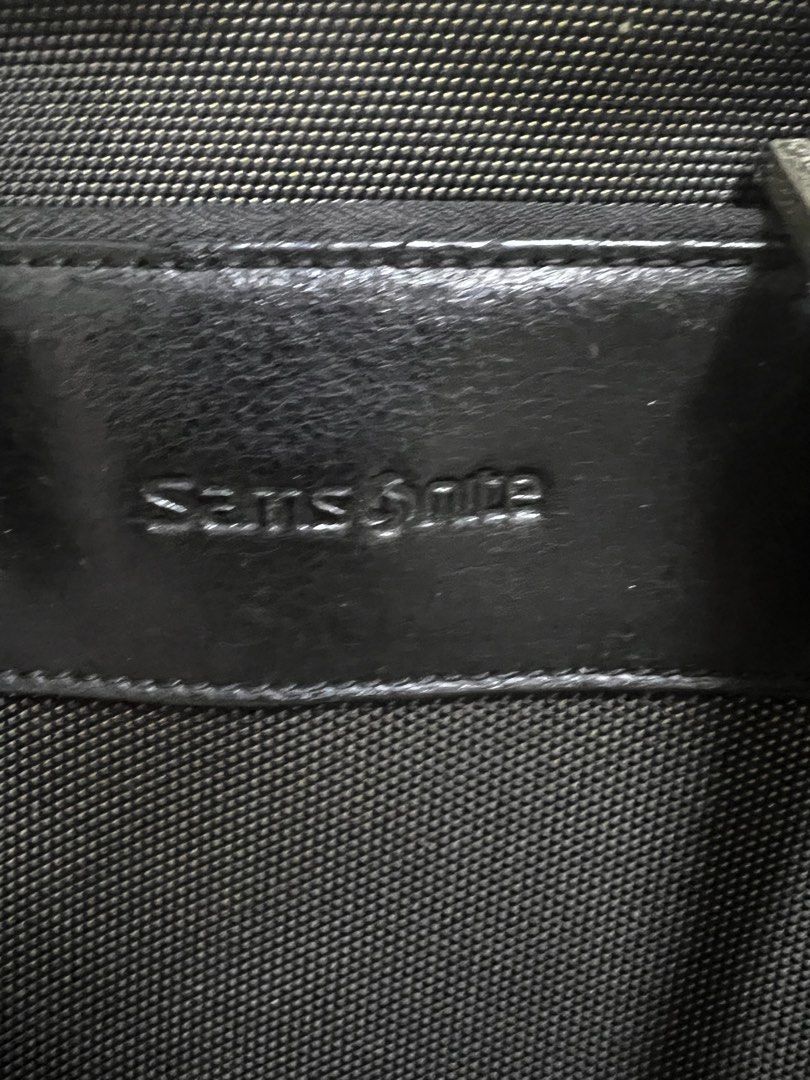 Samsonite Black Briefcase with Shoulder Strap (Category: Briefcases) located in Muntinlupa City. Submitted by ababrl (Listing ID 1397503871, Image 1). Description: - Black Samsonite briefcase - Includes shoulder strap and handle - Interior with multiple compartments - Secure zipper closure - Durable metal hardware - Samsonite logo visible - Dimensions: Approximately 16" wide x 11" tall.