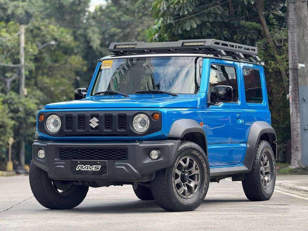 Suzuki Jimny GLX Auto (Category: Used Cars) located in Manila. Submitted by quality_cars (Listing ID 1397545230, Image 3). Description: ❗️New arrival , Quality unit guaranteed❗️ For sale , Cash , Trade in , Financing ✔️2022 acq SUZUKI JIMNY GLX 4x4 Automatic First owned Brisk blue metallic Original flawless paint Upgraded ROOF RACK Thic tires The rest all stock , All original 💯Complete with sales invoice 💯2 original keys 💯Original ORCR 💯No hi