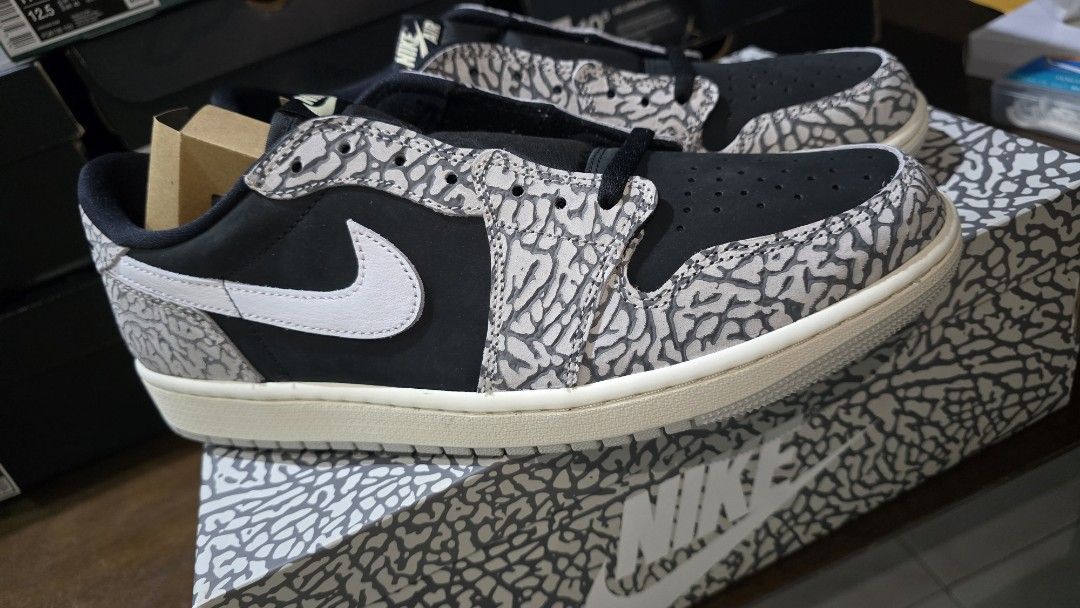 Air Jordan 1 Retro Low OG (Category: Sneakers) located in San Juan City. Submitted by aivveee (Listing ID 1397724518, Image 2). Description: - Air Jordan 1 Low - Elephant print design - Black and grey color scheme - White midsole - Nike swoosh visible - Comes with original box.