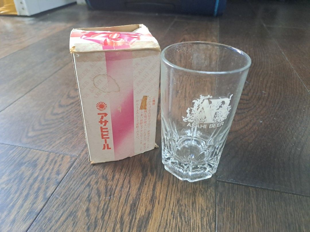 Asahi Beer Glass with Box (Category: Other Kitchenware & Tableware) located in Manila. Submitted by joanbalde39643 (Listing ID 1397631775, Image 2). Description: - Vintage Asahi Beer glass - Includes original box - Features Asahi Beer logo - Box has Japanese text and a pink/white design - Unique faceted base - Ideal for glassware collectors - Great gift for beer enthusiasts.