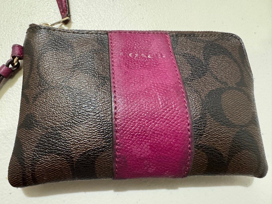 Coach Fuschia wristlet (Category: Wallets & Card holders) located in Taguig. Submitted by codeddreams (Listing ID 1397646692, Image 1). Description: Bought from Coach HK around 2018. have been used well. coach print has already faded but otherwise usable. List price is final..