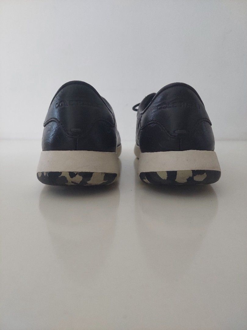 Cole Haan Black Leather Sneakers (Category: Sneakers) located in Pasig City. Submitted by warrenroyo (Listing ID 1397640911, Image 2). Description: - Cole Haan sneakers - Black leather upper - White soles - Textured design - Lace-up closure - Some sole wear - Casual wear.