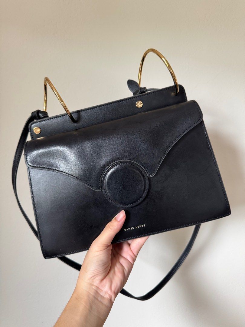 Danse Lente Phoebe Bag in Black (Category: Luxury Bags & Wallets) located in Taguig. Submitted by serialdeclutterer (Listing ID 1397644549, Image 1). Description: With a few scuff marks but overall in good condition. Structure is still great unlike other preloved Phoebe bags in the market. Includes dust bag and authenticity cards RFS: Doesn’t fit my WFH lifestyle anymore :).