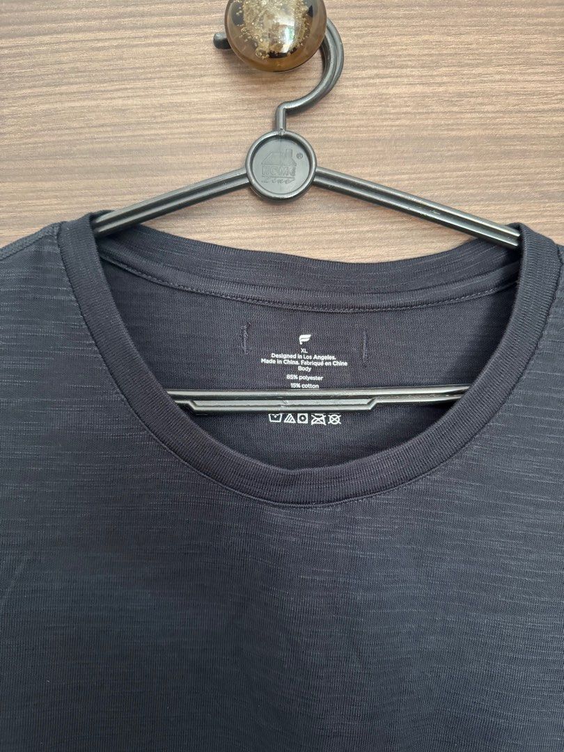 Fabletics Men's Front Row Tee - Black (Category: Activewear) located in Singapore. Submitted by jeepfries (Listing ID 1397647708, Image 3). Description: - Fabletics training tee, Kevin Hart’s sportswear line - Perfect for workouts or casual wear - Comfortable - Features a crew neck and short sleeves - Subtle textured pattern The photos at the end with the model wearing the top in red colour is the exact same top, just in a different colour Brand 