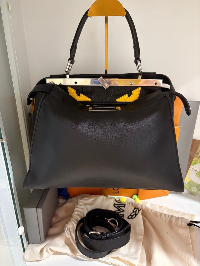 Fendi Peekaboo Medium Monster Eye (Category: Luxury Bags & Wallets) located in Bulacan. Submitted by heiresslovecloset (Listing ID 1397652616, Image 1). Description: - Authentic Fendi Peekaboo handbag with Monster Eyes design - Medium Size -Black Calfskin leather/Phyton skin lining -Top handle and detachable shoulder strap - Interior zipper pocket - Silver hardware - Unique clasp closure Flaws; *Missing few screws* Side buttons replaced* Length :
