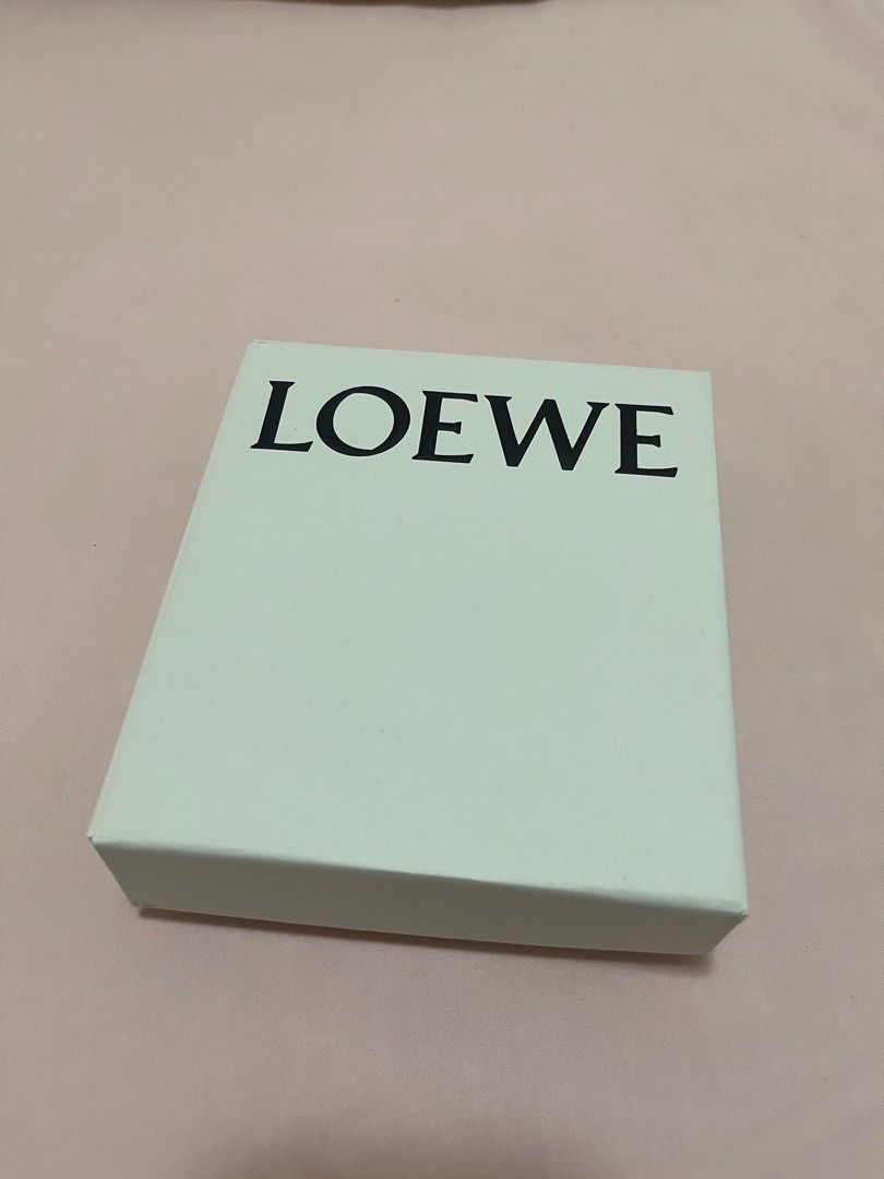 Loewe Leather Strap Anagram Tan/Gold (Category: Luxury Bags & Wallets) located in San Juan City. Submitted by mnatividad (Listing ID 1397713783, Image 2). Description: -Loewe leather strap -Color: Tan/Gold - Includes: Box, Small pouch, charm, original box - Strap Details: Brown/Tan with knot detail .