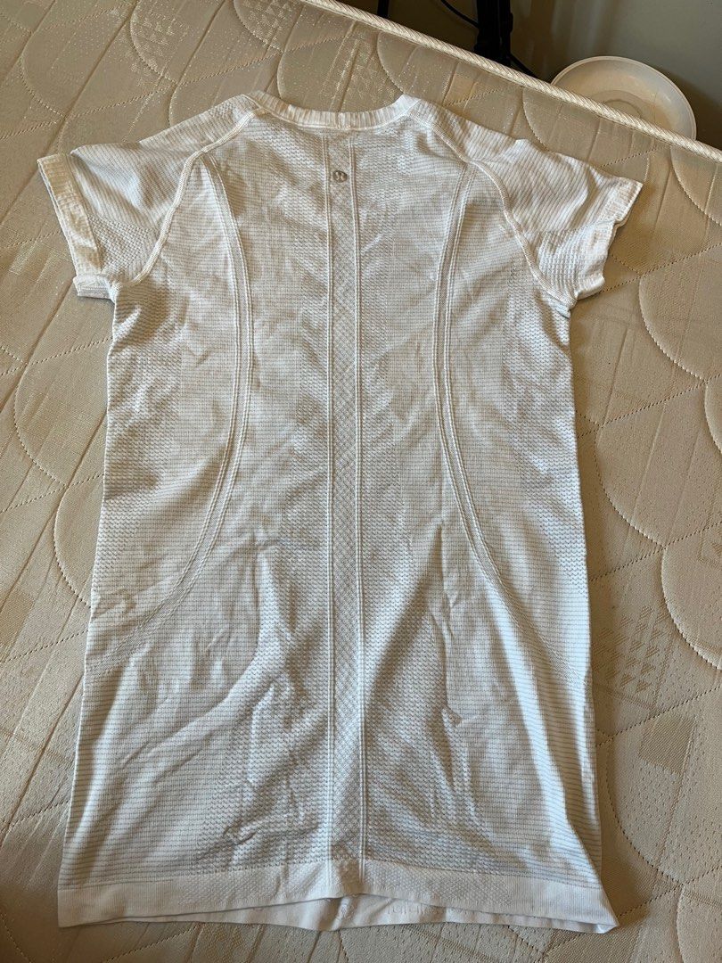 Lululemon Swiftly Tech Short Sleeve Shirt (Category: Activewear) located in Quezon City. Submitted by krtstn (Listing ID 1397657490, Image 2). Description: - Lululemon Swiftly Tech short sleeve shirt - Color: White - Crew neck - Seamless design - Fitted silhouette - Textured pattern - Lululemon logo on back - Short sleeves - Straight hemline.