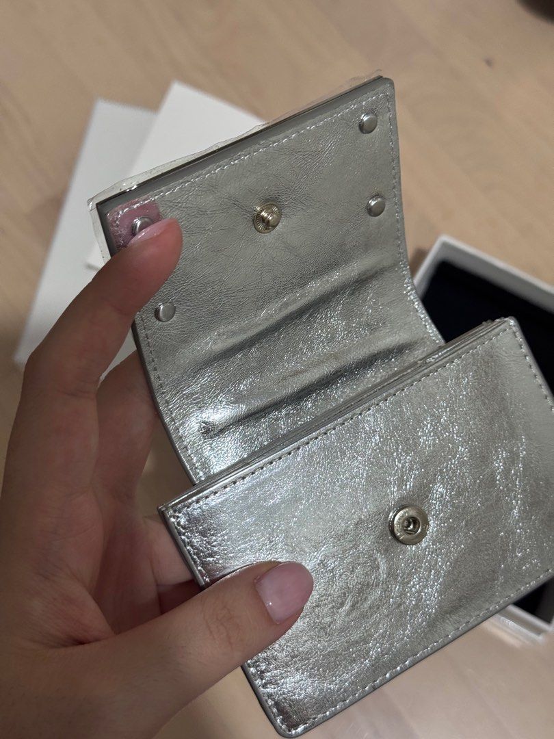 Matin Kim Accordion Silver Wallet (Category: Wallets & Card holders) located in Manila. Submitted by ephtans (Listing ID 1397689829, Image 3). Description: brand new matin kim accordion wallet in silver, never used (just opened the item) comes with original box, and everything! there’s a little bubble but there’s no problem as it subsides after use :) fits 5-6 cards and cash comfortably !! super cool to take around it’s guaranteed authentic! pric