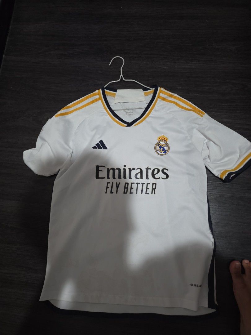 Real Madrid Adidas Jersey (Category: Activewear) located in Singapore. Submitted by hithere123456 (Listing ID 1397744521, Image 1). Description: - Adidas logo - Emirates Fly Better sponsor - White with gold accents.