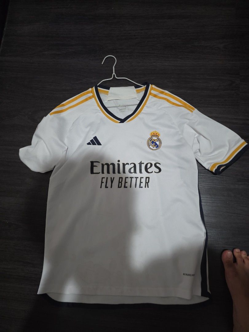 Real Madrid Adidas Jersey (Category: Activewear) located in Singapore. Submitted by hithere123456 (Listing ID 1397744521, Image 2). Description: - Adidas logo - Emirates Fly Better sponsor - White with gold accents.