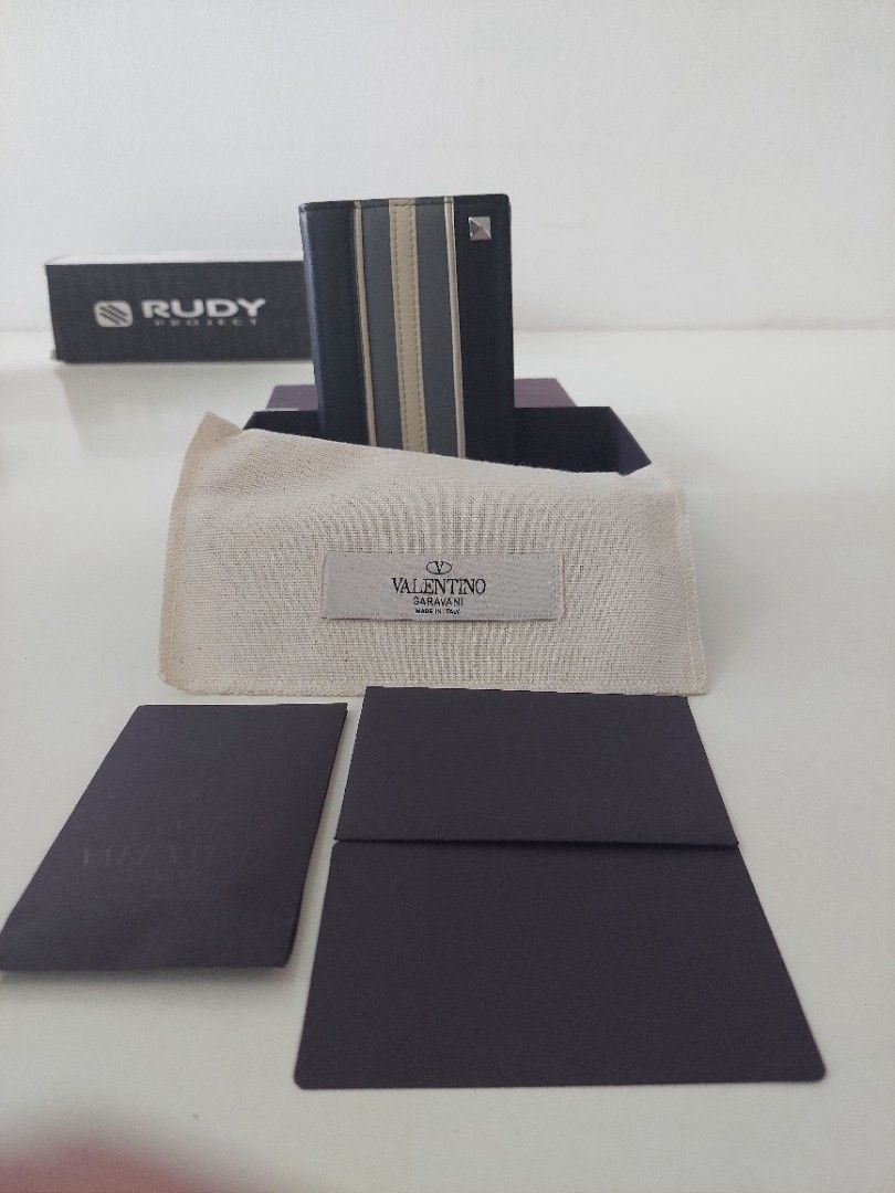 Valentino Garavani Striped Wallet (Category: Luxury Bags & Wallets) located in Pasig City. Submitted by warrenroyo (Listing ID 1397640341, Image 2). Description: - Authentic Valentino Garavani wallet - Black leather exterior - Features beige and blue vertical stripes - Includes original box and dust bag - Multiple card slots and bill compartment - Valentino Garavani logo inside - Made in Italy.