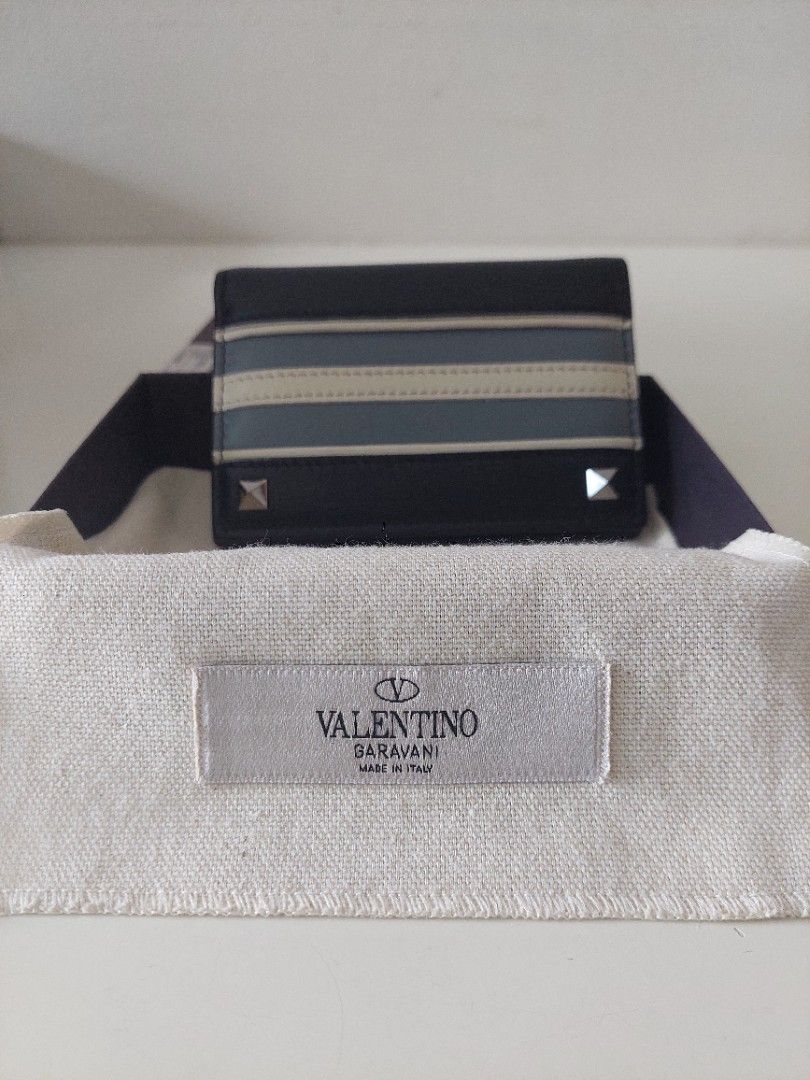 Valentino Garavani Striped Wallet (Category: Luxury Bags & Wallets) located in Pasig City. Submitted by warrenroyo (Listing ID 1397640341, Image 3). Description: - Authentic Valentino Garavani wallet - Black leather exterior - Features beige and blue vertical stripes - Includes original box and dust bag - Multiple card slots and bill compartment - Valentino Garavani logo inside - Made in Italy.