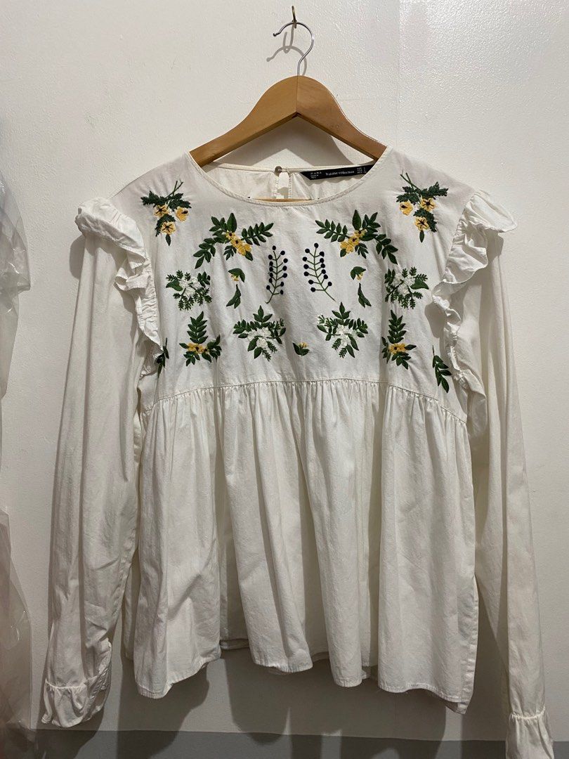 Zara Trafaluc Embroidered Blouse - Size L (Category: Blouses) located in Manila. Submitted by zapitup (Listing ID 1397704046, Image 2). Description: - Zara Trafaluc blouse - Floral embroidery - Long sleeves - Ruffle details on shoulders - Round neckline - Gathered waist - Made in India - Size: L.