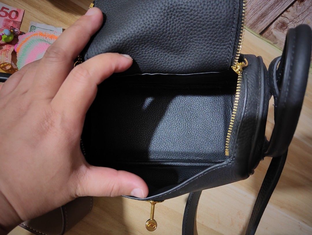 Black Handbag with Gold Hardware Lindy (Category: Luxury Bags & Wallets) located in Manila. Submitted by mayparaiso (Listing ID 1397848024, Image 2). Description: selling this original cowhide. design ins. Lindy small size can fit phone and wallet inside bought from china.