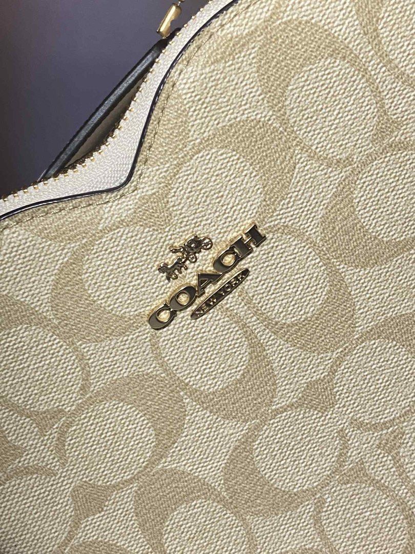 Coach Heart-Shaped Bag (Category: Luxury Bags & Wallets) located in Iba. Submitted by gotmethrift (Listing ID 1397883585, Image 2). Description: - Authentic Coach bag - Unique heart shape - Signature Coach pattern - Top handle - Zip closure - Made in Vietnam - Gold-toned hardware - White trim - Includes Coach tag - Coach interior label.