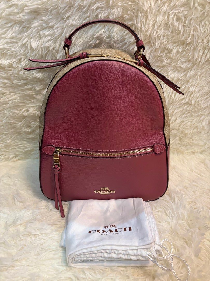 Coach Pink and Beige Jordyn Backpack (Category: Luxury Bags & Wallets) located in Manila. Submitted by _thepursela (Listing ID 1397967037, Image 1). Description: Coach backpack features a pink front and beige sides with the Coach logo pattern. It has a top handle, adjustable straps, and a front zipper pocket. The interior is pink and includes a Coach tag. It comes with a dust bag. The hardware is gold-toned..