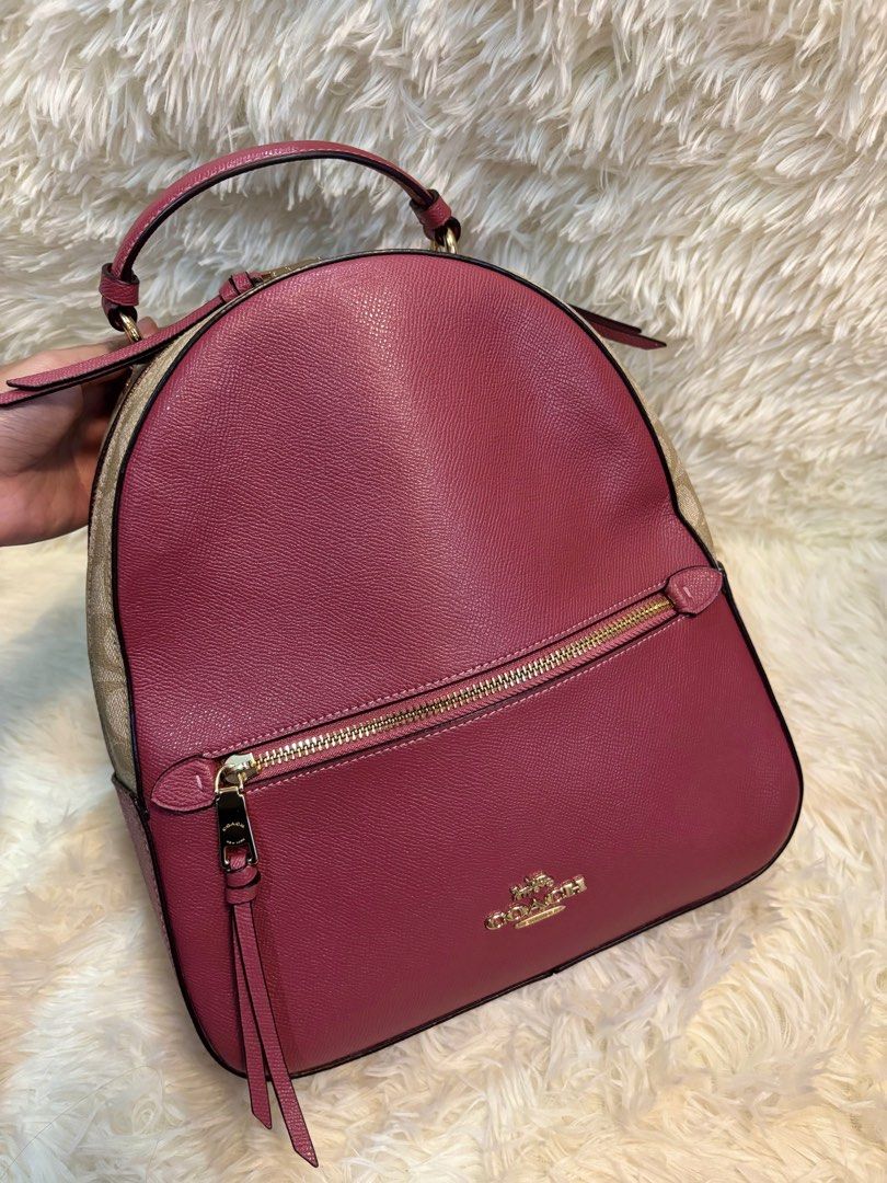 Coach Pink and Beige Jordyn Backpack (Category: Luxury Bags & Wallets) located in Manila. Submitted by _thepursela (Listing ID 1397967037, Image 2). Description: Coach backpack features a pink front and beige sides with the Coach logo pattern. It has a top handle, adjustable straps, and a front zipper pocket. The interior is pink and includes a Coach tag. It comes with a dust bag. The hardware is gold-toned..