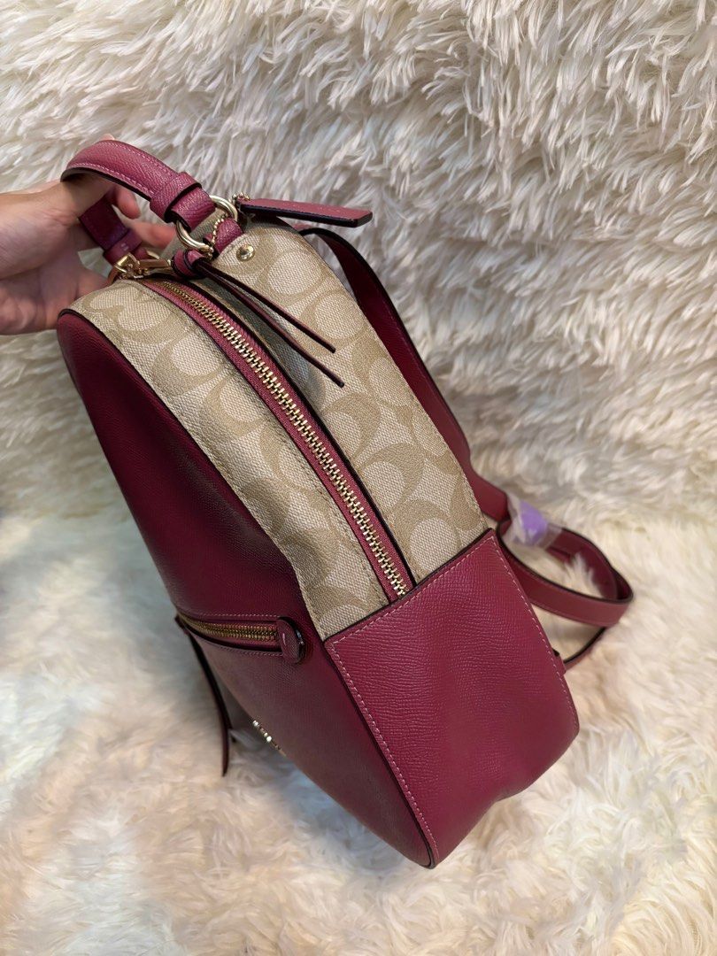 Coach Pink and Beige Jordyn Backpack (Category: Luxury Bags & Wallets) located in Manila. Submitted by _thepursela (Listing ID 1397967037, Image 3). Description: Coach backpack features a pink front and beige sides with the Coach logo pattern. It has a top handle, adjustable straps, and a front zipper pocket. The interior is pink and includes a Coach tag. It comes with a dust bag. The hardware is gold-toned..