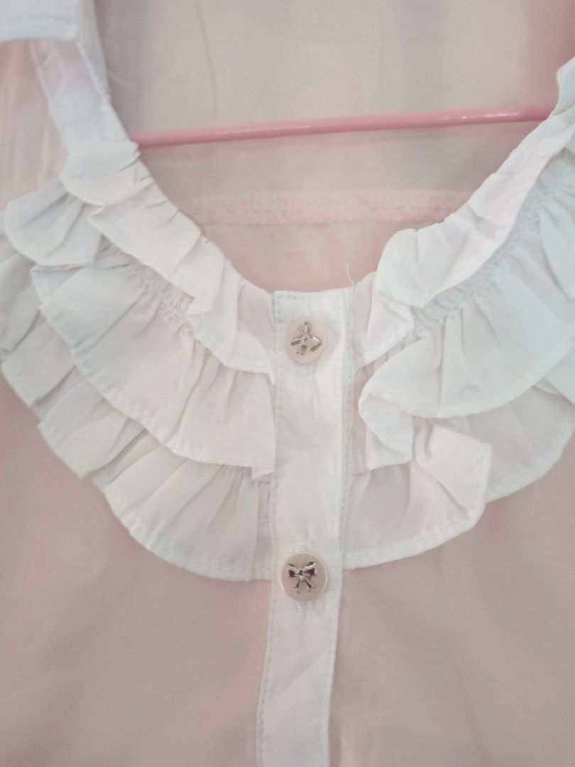 Coquette Pink Ruffle Blouse with White Collar (Category: Blouses) located in Dagupan City. Submitted by ciatrine (Listing ID 1397862273, Image 2). Description: - coquette pink blouse xs to small - White collar and cuffs - Ruffled front detail - Button-down closure with decorative ribbon buttons - Long sleeves - Lightweight material.