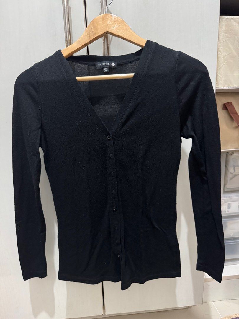 Cotton On Black Cardigan - Size S (Category: Coats, Jackets and Outerwear) located in Mandaluyong City. Submitted by declutcore (Listing ID 1397936862, Image 1). Description: - Cotton On black cardigan - Size: Small - Features a V-neck - Long sleeves - Button-up front - Made in China.