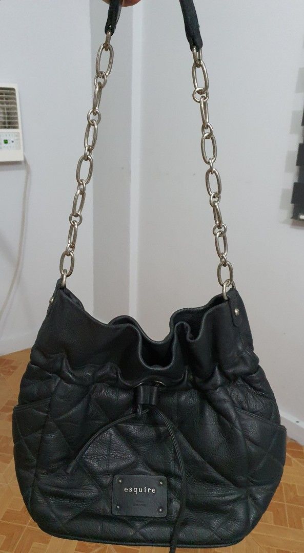 Esquire Black Quilted Shoulder Bag (Category: Shoulder Bags) located in Pasig City. Submitted by markieng (Listing ID 1397920602, Image 2). Description: - Black Esquire shoulder bag - Quilted design - Drawstring closure - Silver chain straps - Small exterior pocket - Rectangular brand tag - Made of leather.