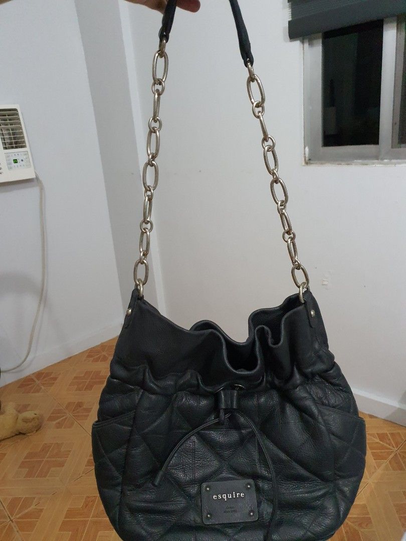 Esquire Black Quilted Shoulder Bag (Category: Shoulder Bags) located in Pasig City. Submitted by markieng (Listing ID 1397920602, Image 3). Description: - Black Esquire shoulder bag - Quilted design - Drawstring closure - Silver chain straps - Small exterior pocket - Rectangular brand tag - Made of leather.