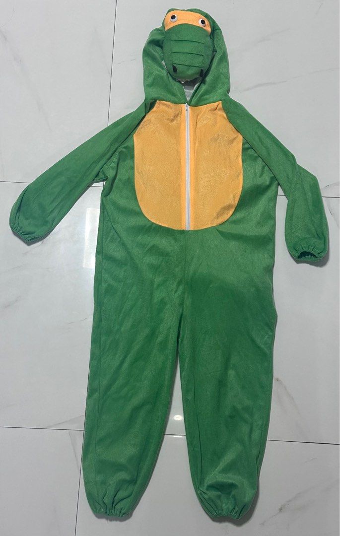 Green Dinosaur Costume with Hood (Category: Babies & Kids Fashion) located in Manila. Submitted by chamwel (Listing ID 1397788145, Image 1). Description: - Green dinosaur costume - Features a dinosaur face hood - Includes a yellow belly - Long sleeves and elastic cuffs - Purple spikes and tail detail - One-piece design - Zipper closure.