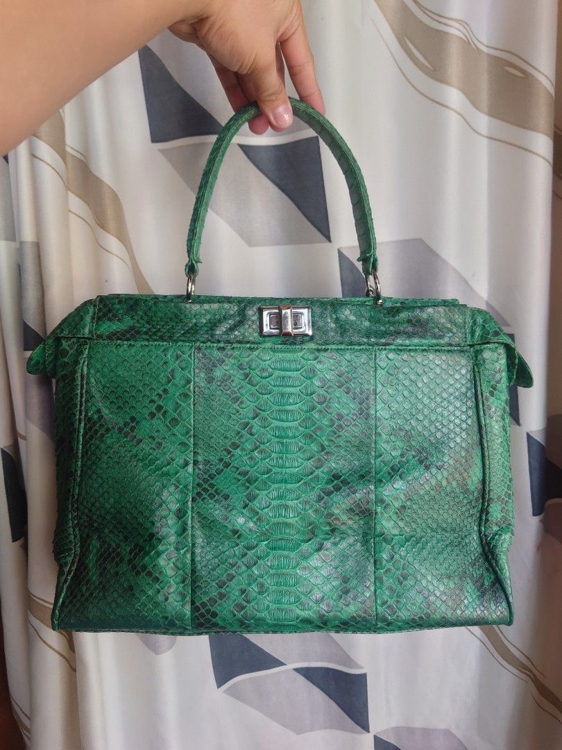 Green Snakeskin Handbag (Category: Purses & Pouches) located in Caloocan City. Submitted by thon0806 (Listing ID 1397817567, Image 1). Description: - Green snakeskin pattern - Top handle - Rectangular shape - Silver clasp and hardware - Interior zippered pocket - Leather construction .