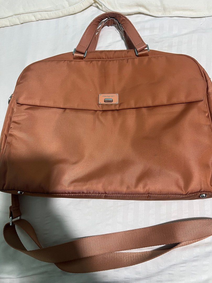Original Hedgren Laptop Bag (Category: Laptop Bags & Sleeves) located in Taguig. Submitted by miasfinds (Listing ID 1397898454, Image 1). Description: - Original Brown Orange Hedgren laptop bag - Includes a shoulder strap and top handles - Multiple compartments for organization - Padded section for laptop - RFID protected compartment - See photos for flaws. Just the handle. .