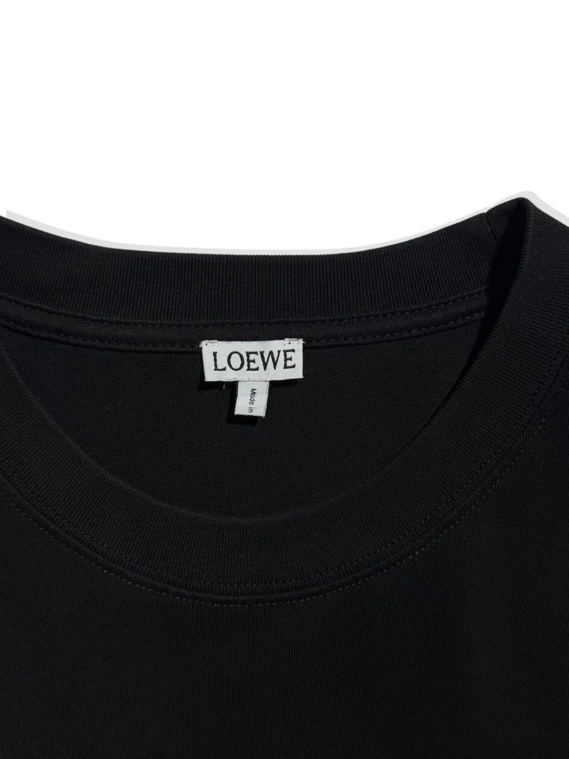 Loewe Embroidered Logo T-shirt (Category: Tshirts & Polo Shirts ) located in Cebu City. Submitted by stylehub_ (Listing ID 1397815440, Image 3). Description: - Black Loewe T-shirt - Best fit: L - Width: 22 - Length: 27.5 - Pink embroidered logo - Crew neck - Short sleeves - Made in Portugal - 100% cotton - Features Loewe logo on neck and front.