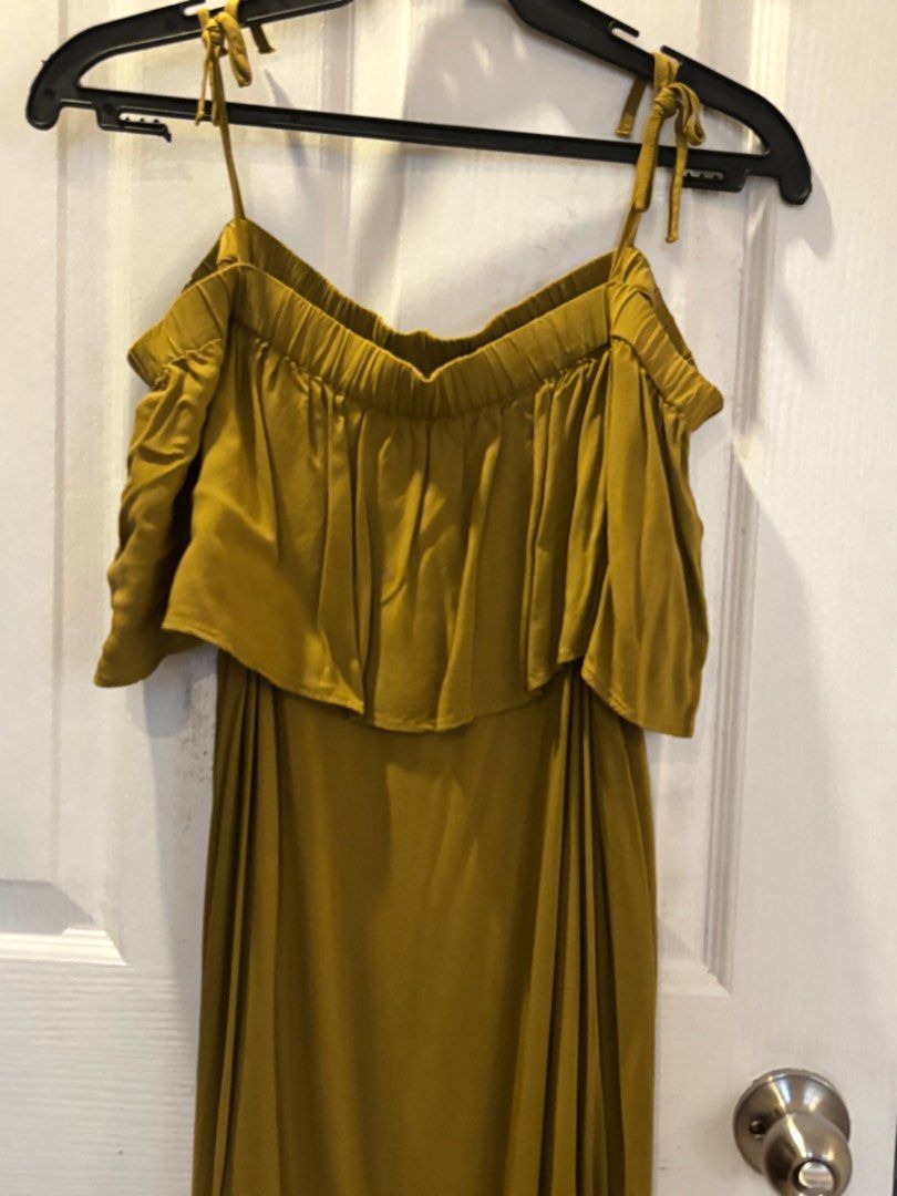 Olive Green Off-Shoulder Dress (Category: Dresses) located in San Fernando. Submitted by lyzcartz (Listing ID 1397917004, Image 2). Description: - Olive green off-shoulder dress - Features tie straps - Layered bodice - Flowing skirt - Midi length - Made of smooth fabric (possibly satin).