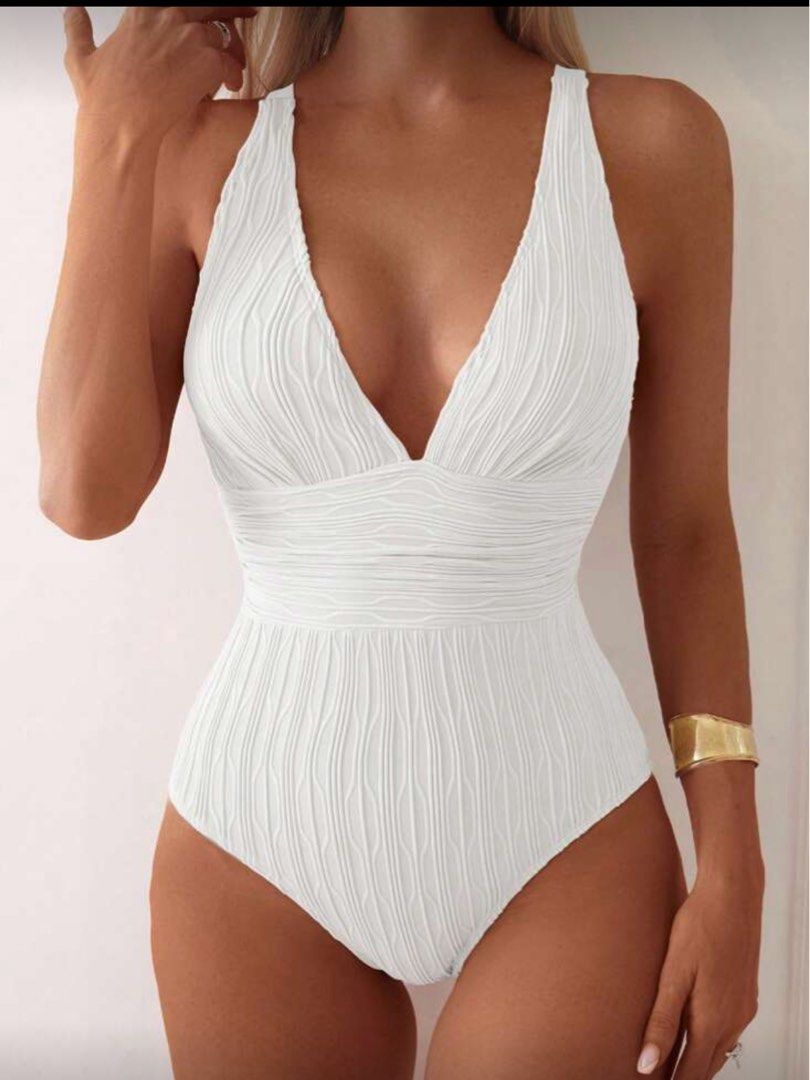 One Piece Strap White Textured Swimsuit (Category: Bikinis & Swimsuits) located in Manila. Submitted by _boxofelle (Listing ID 1397816820, Image 1). Description: - White textured one-piece swimsuit - Features a flattering V-neck - Adjustable straps for a custom fit - Ideal for swimming and beach activities Brand new, never been used Rfs: Not my style.