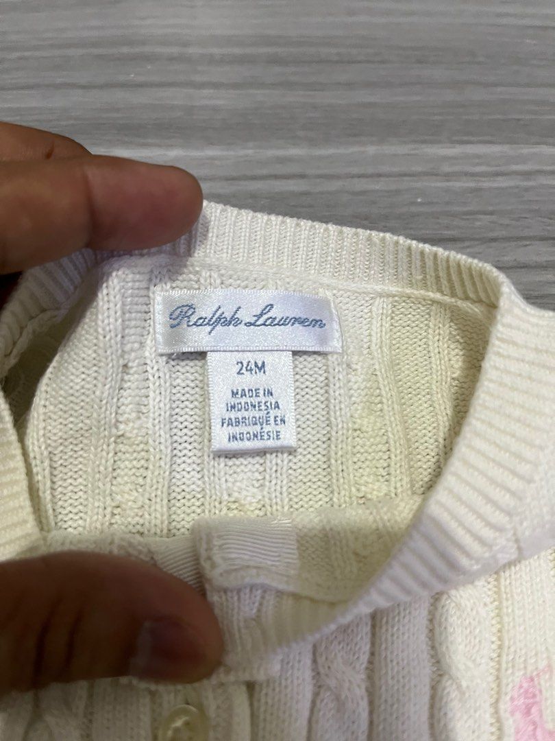 Ralph Lauren Cable Knit Cardigan 24M (Category: Babies & Kids Fashion) located in Manila. Submitted by kenriegab (Listing ID 1397862609, Image 3). Description: - Ralph Lauren cable knit cardigan - Cream color - Size: 24 months - Classic button-down style - Polo logo - Made in Indonesia - Minor stain on sleeve - Perfect for layering Dimes: L 12 x W 12 Excellent condition Minor issue may washable stain sa last pic +shipping.