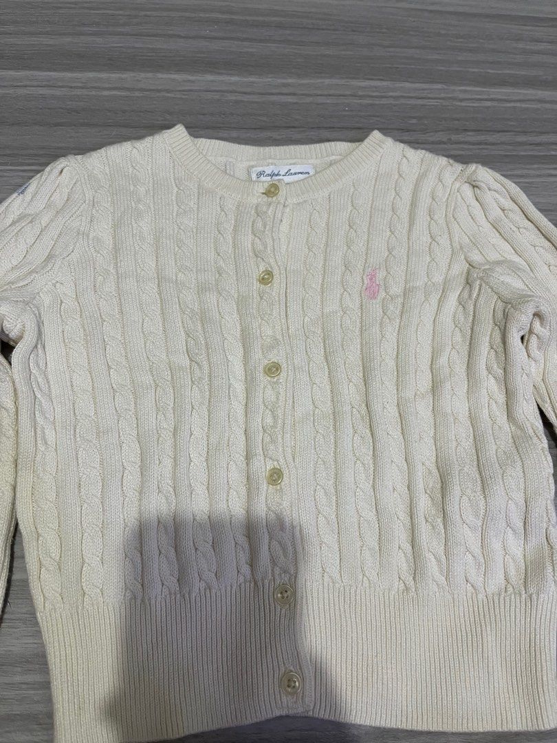 Ralph Lauren Cable Knit Cardigan 24M (Category: Babies & Kids Fashion) located in Manila. Submitted by kenriegab (Listing ID 1397862609, Image 2). Description: - Ralph Lauren cable knit cardigan - Cream color - Size: 24 months - Classic button-down style - Polo logo - Made in Indonesia - Minor stain on sleeve - Perfect for layering Dimes: L 12 x W 12 Excellent condition Minor issue may washable stain sa last pic +shipping.