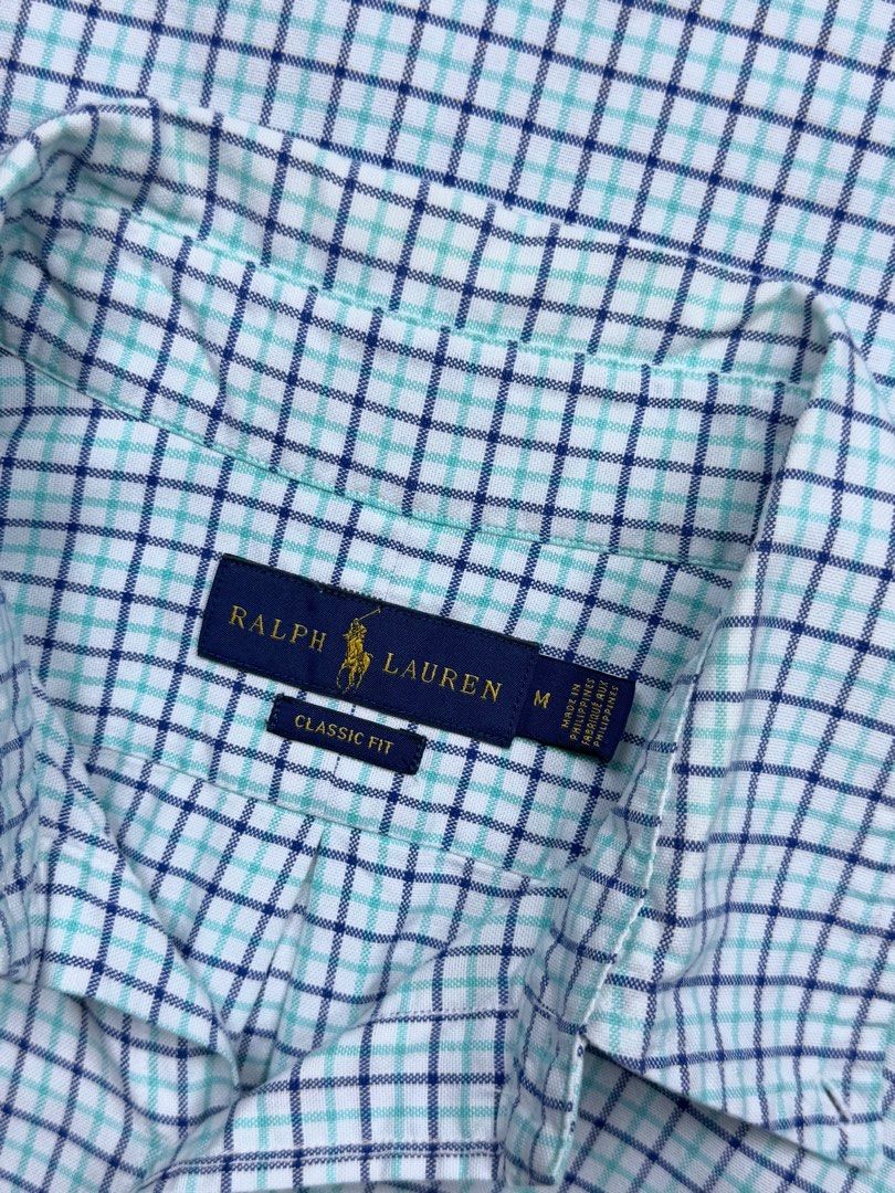 Ralph Lauren Classic Fit Checkered Shirt (Category: Tshirts & Polo Shirts ) located in Cebu City. Submitted by stylehub_ (Listing ID 1397809941, Image 3). Description: - Ralph Lauren Classic Fit shirt - Size: M -Width: 23 -Length 28/29 - Pattern: Blue and white checkered - Features a button-down collar - Embroidered Ralph Lauren logo - Made in the Philippines.