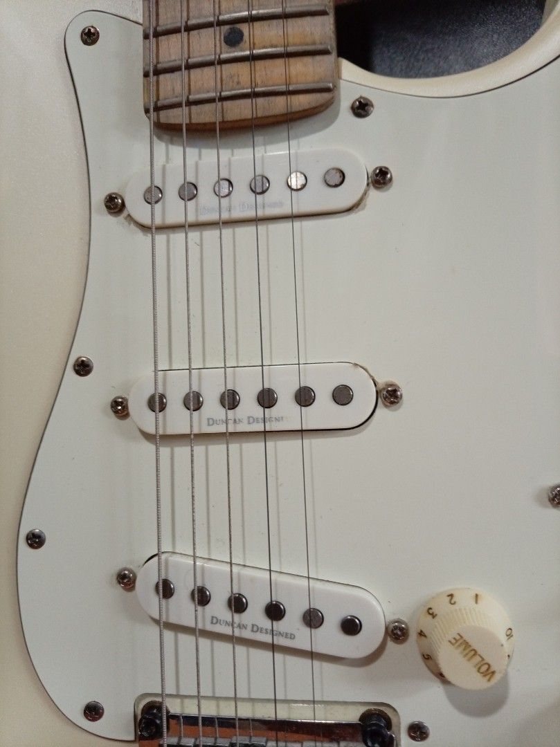 Squier by Fender Stratocaster Electric Guitar (Category: Musical Instruments) located in Agdangan. Submitted by hairulmusicalcolection (Listing ID 1397855074, Image 3). Description: - Squier by Fender Stratocaster - Classic pearl white body - Comfortable maple neck - Equipped with three single-coil pickups - Features a tremolo bridge - Includes volume and tone controls - Authentic Fender headstock with Squier logo - Serial number and "Crafted in 