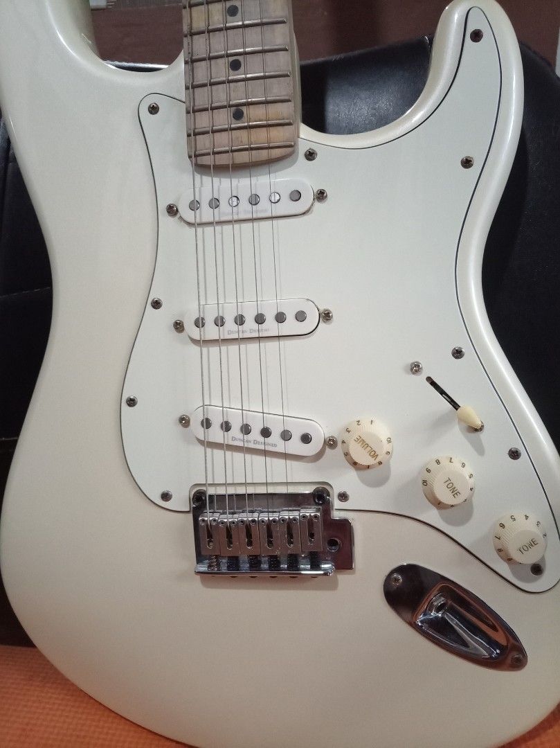 Squier by Fender Stratocaster Electric Guitar (Category: Musical Instruments) located in Agdangan. Submitted by hairulmusicalcolection (Listing ID 1397855074, Image 2). Description: - Squier by Fender Stratocaster - Classic pearl white body - Comfortable maple neck - Equipped with three single-coil pickups - Features a tremolo bridge - Includes volume and tone controls - Authentic Fender headstock with Squier logo - Serial number and "Crafted in 