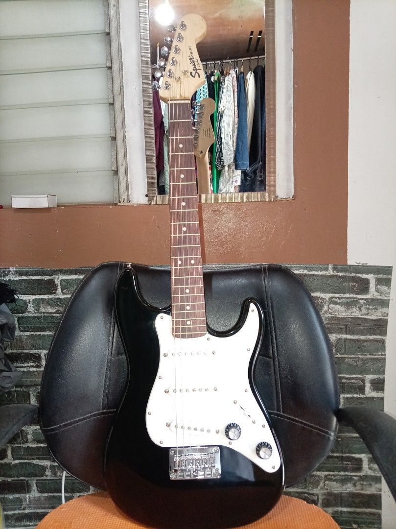 Squier Mini Fender Electric Guitar (Category: Musical Instruments) located in Agdangan. Submitted by hairulmusicalcolection (Listing ID 1397835491, Image 1). Description: - Squier Mini Fender electric guitar - Color: Black - Features: - Maple neck - Black body - Six strings - Tremolo bridge - Includes two control knobs - Headstock with Squier Mini Fender logo - Made in Indonesia.