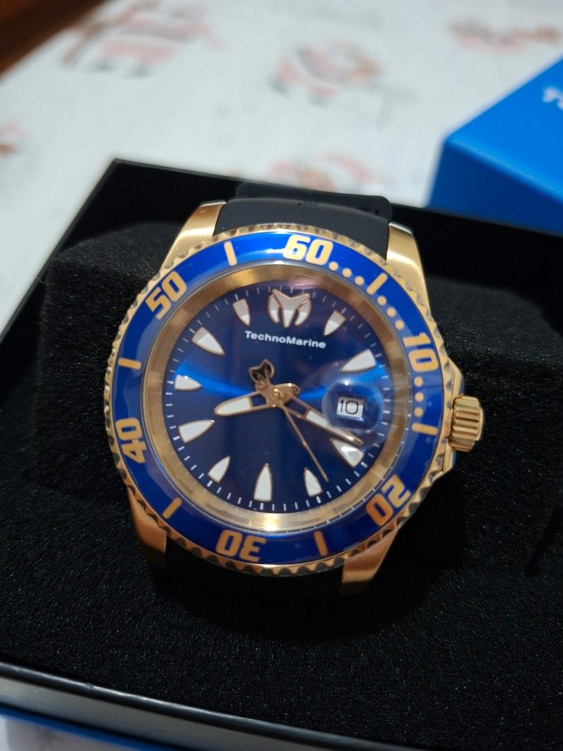 TechnoMarine Gold Plated Watch (Category: Men's Watches) located in Pasay City. Submitted by Tini_winnie (Listing ID 1397909271, Image 1). Description: - TechnoMarine watch - Model: sea manta - Gold-plated case - Blue bezel - Dark blue dial - Gold-tone hands and markers - Black rubber strap - Includes original box - New and unworn - From US - 42mm - mop: gcash or bpi.