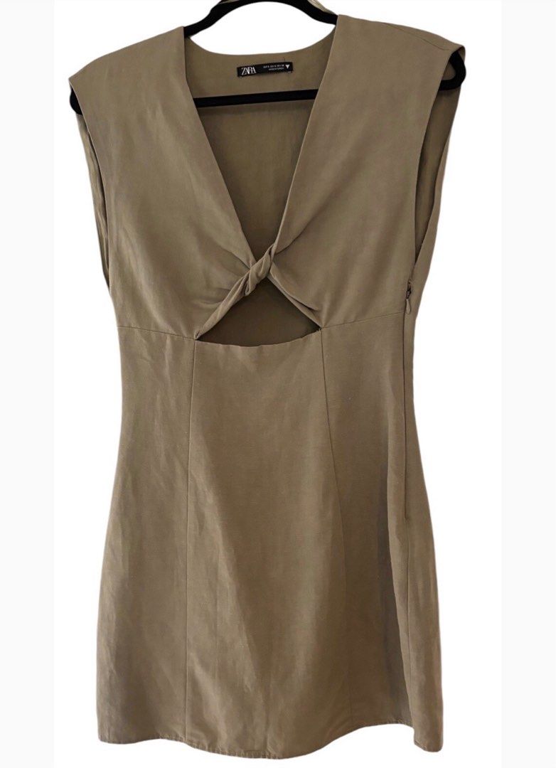 Zara Linen Blend Short Dress (Category: Dresses) located in Paranaque City. Submitted by zipperou (Listing ID 1397889650, Image 2). Description: - Zara linen blend short dress - V-neckline with knot detail - Cut-out design - Cap sleeves - Neutral color - Size: Small - fixed price Decluttering.