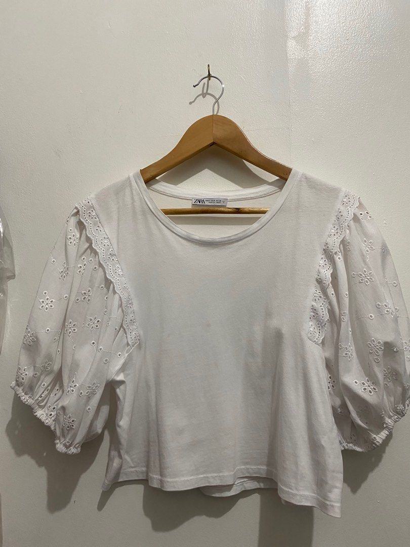 Zara White Eyelet Sleeve Top (Category: Blouses) located in Manila. Submitted by zapitup (Listing ID 1397970387, Image 1). Description: - Zara white top - Eyelet sleeves with floral design - Round neckline - Short, puffy sleeves - Solid white color.