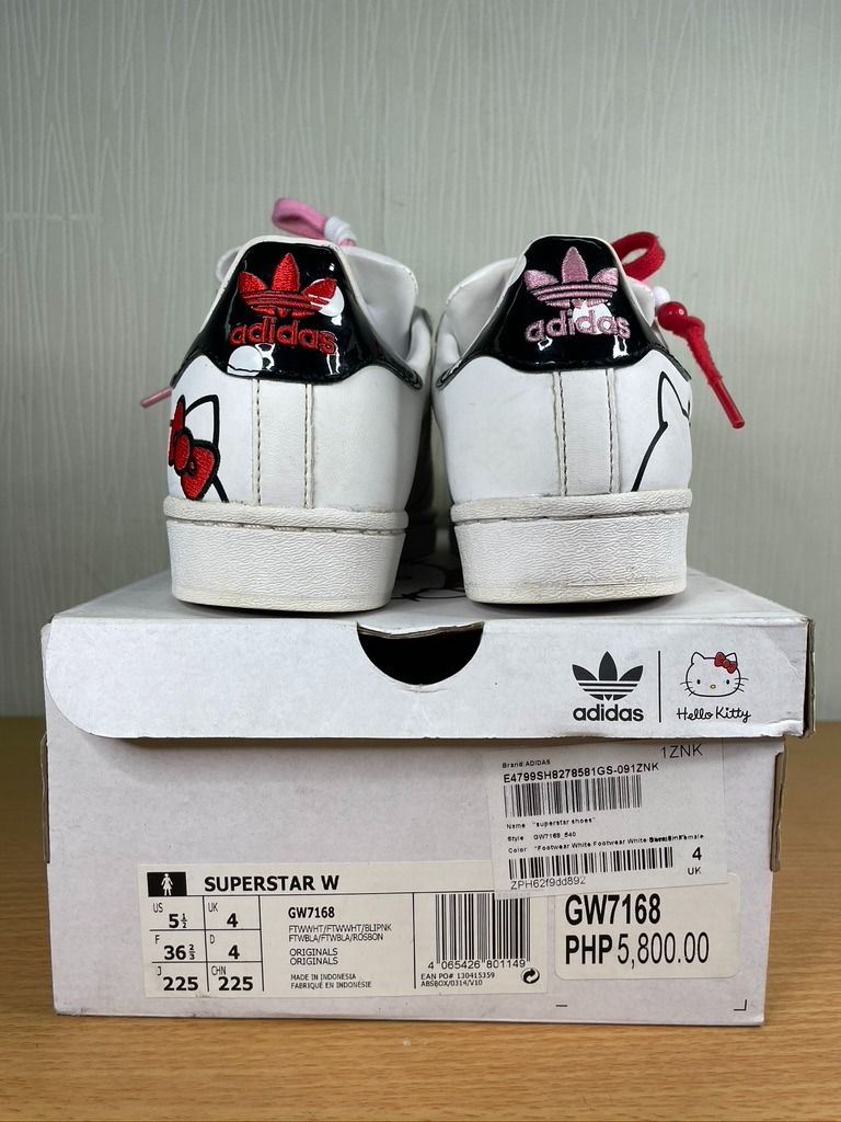 Adidas x Hello Kitty Superstar W Sneakers (Category: Sneakers) located in San Juan City. Submitted by declutterdiariesmnl (Listing ID 1398059489, Image 3). Description: - Adidas x Hello Kitty Superstar W Sneakers - Size US 5.5 / UK 4 - White leather upper - Features Kitty graphics and red bow details - Comes with pink and red laces - Includes original box Item is located in METRO MANILA. Grab / Lalamove booking is PREFERRED, and pickup/delivery a